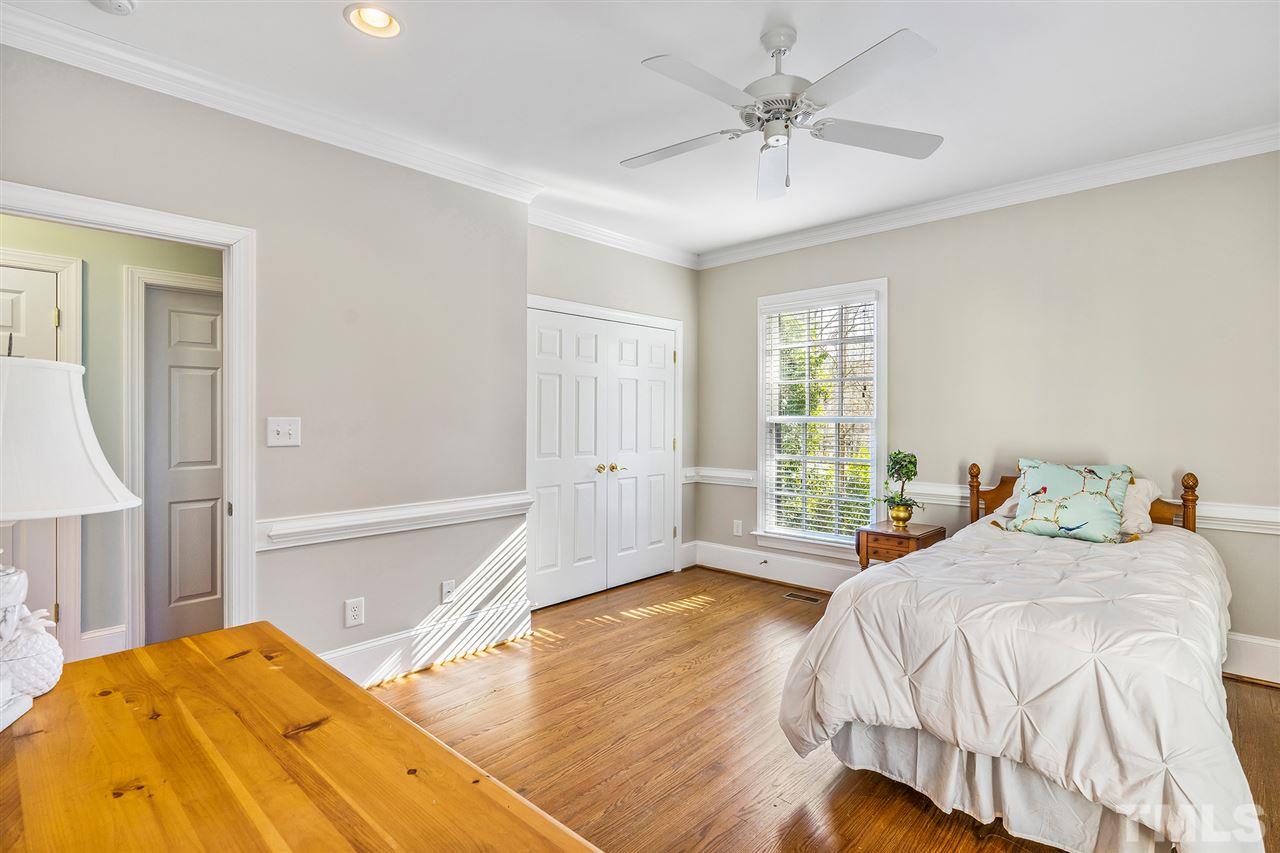 3201 Landor Road Raleigh, NC 27609 - Photo 16 of 25 a bedroom with a bed and a large window with wooden floor