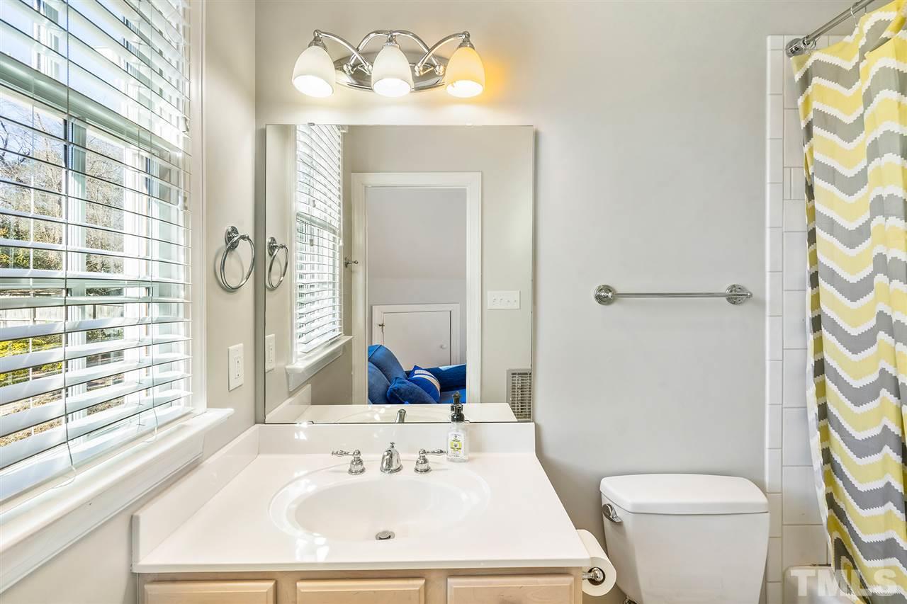 3201 Landor Road Raleigh, NC 27609 - Photo 19 of 25 a bathroom with a sink a toilet and shower curtain