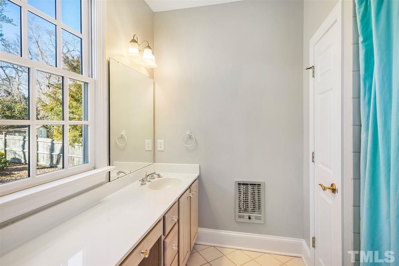 3201 Landor Road Raleigh, NC 27609 - Photo 21 of 25 a bathroom with a tub sink and mirror
