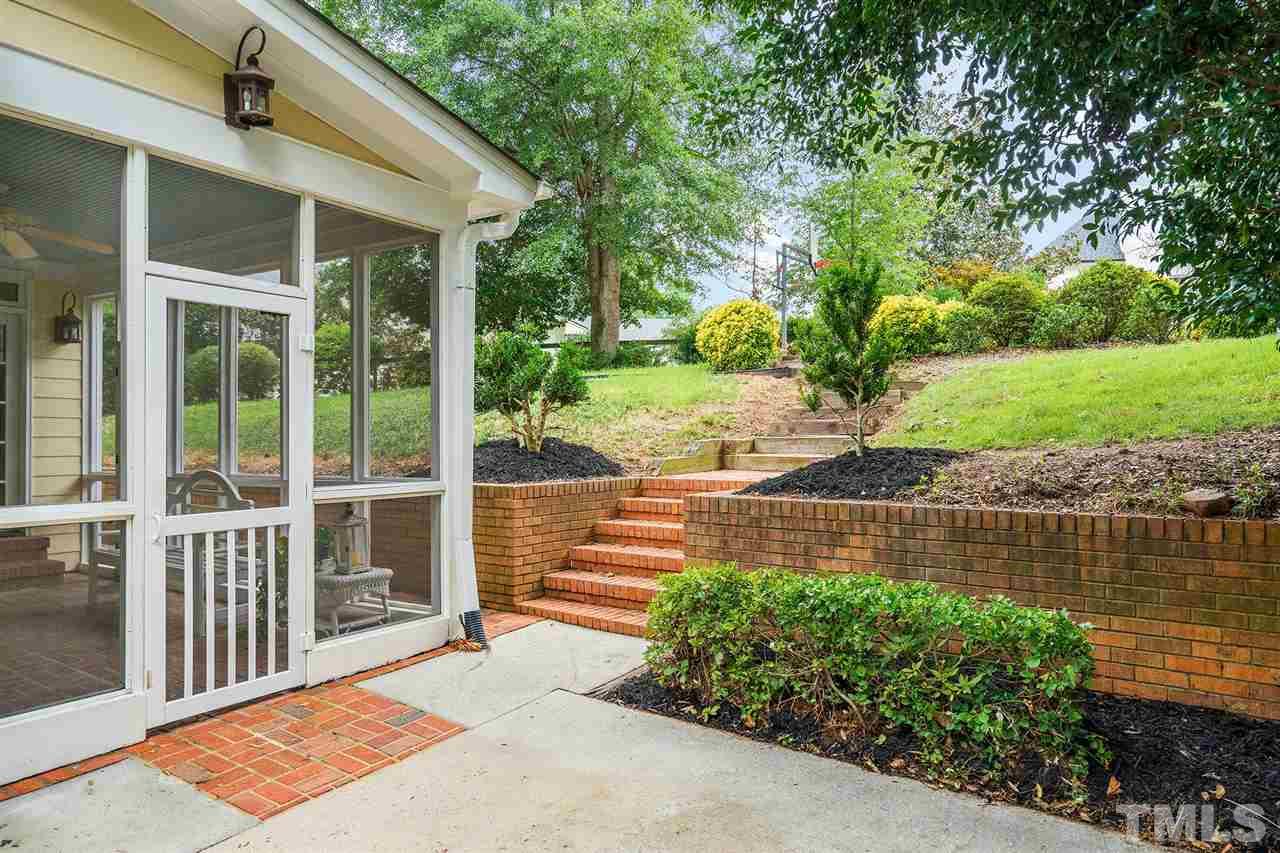 3201 Landor Road Raleigh, NC 27609 - Photo 24 of 25 a view of a backyard with plants and lake view