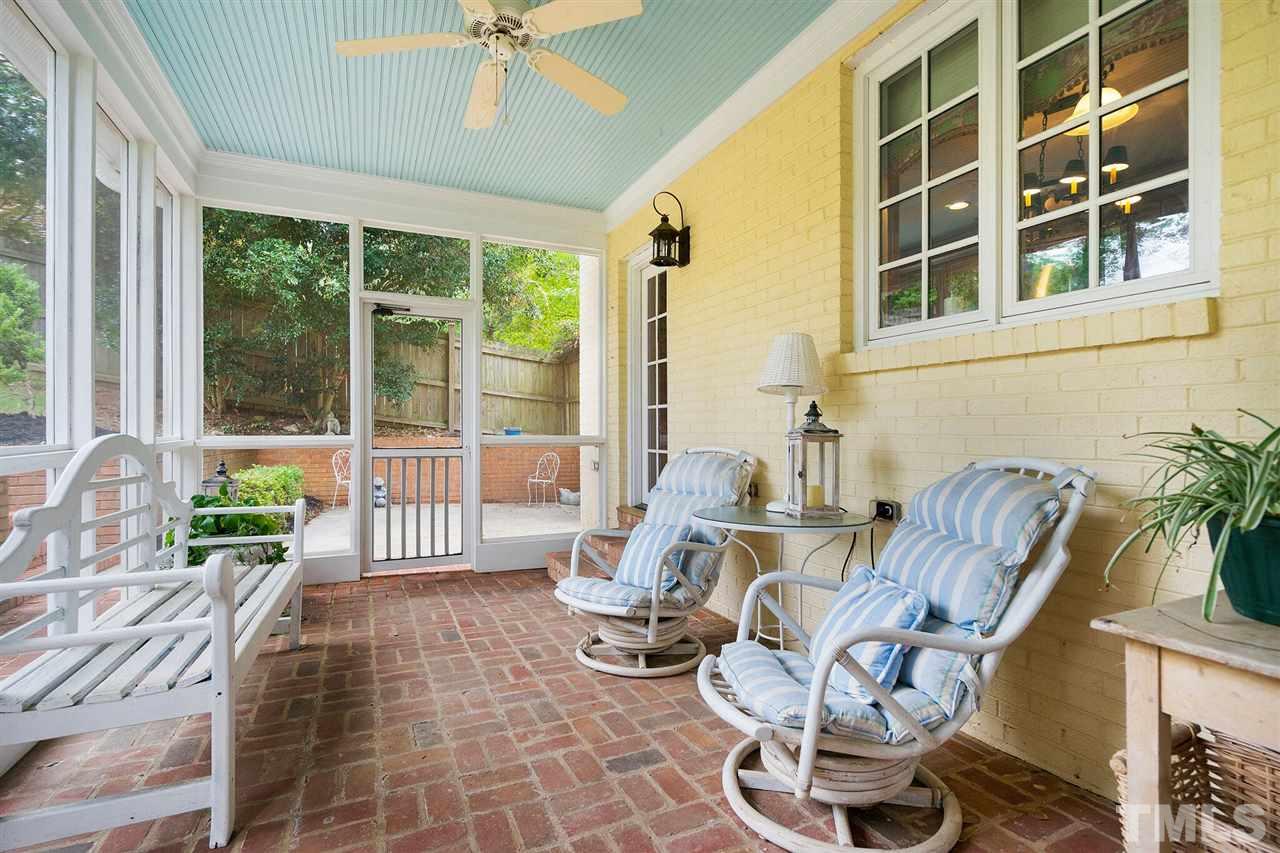 a view of a patio with a dining table and chairs