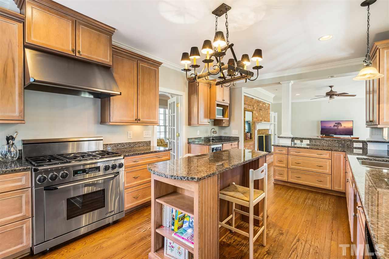 3201 Landor Road Raleigh, NC 27609 - Photo 8 of 25 a kitchen with stainless steel appliances granite countertop a stove and cabinets