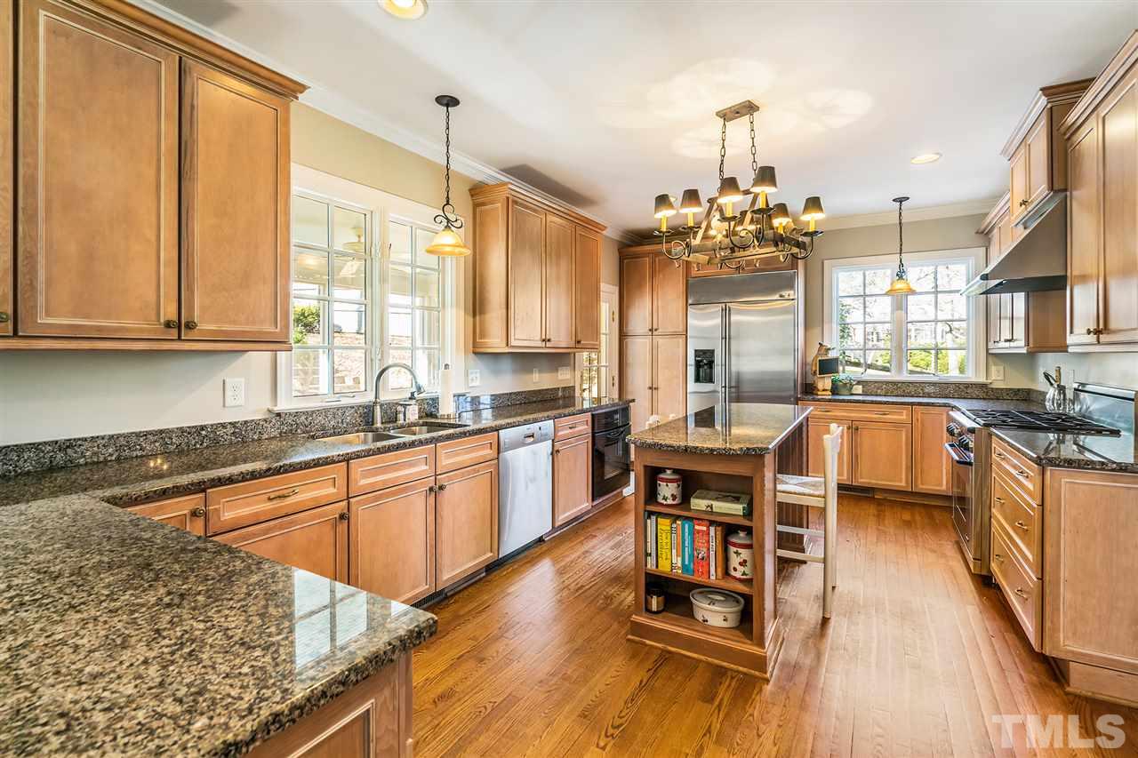 3201 Landor Road Raleigh, NC 27609 - Photo 9 of 25 a kitchen with stainless steel appliances granite countertop sink stove top oven and cabinets