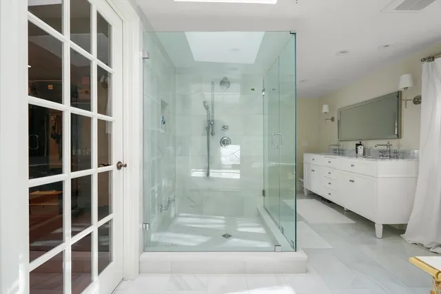 a bathroom with a shower and a sink