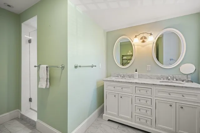 a bathroom with a granite countertop toilet sink and mirror