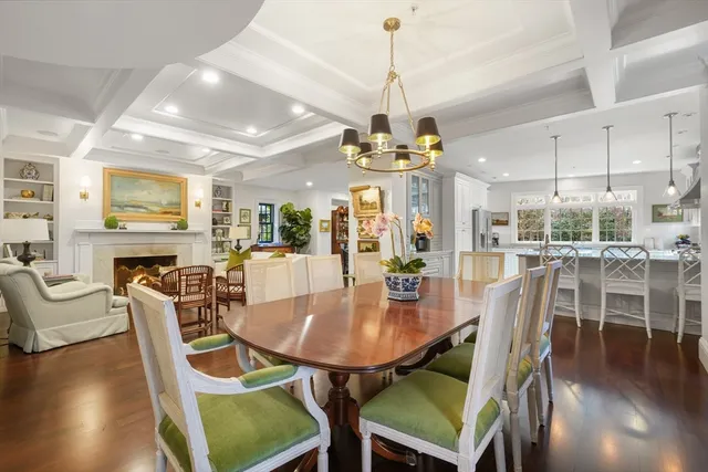 a dining room with furniture a chandelier and wooden floor