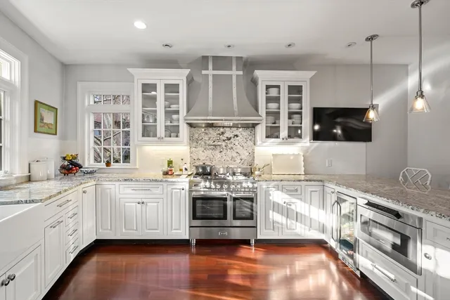 a kitchen with stainless steel appliances granite countertop a stove and cabinets