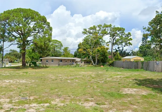 a backyard of a house with lots of green space and fountain