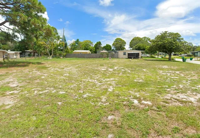 a swimming pool with outdoor seating and yard