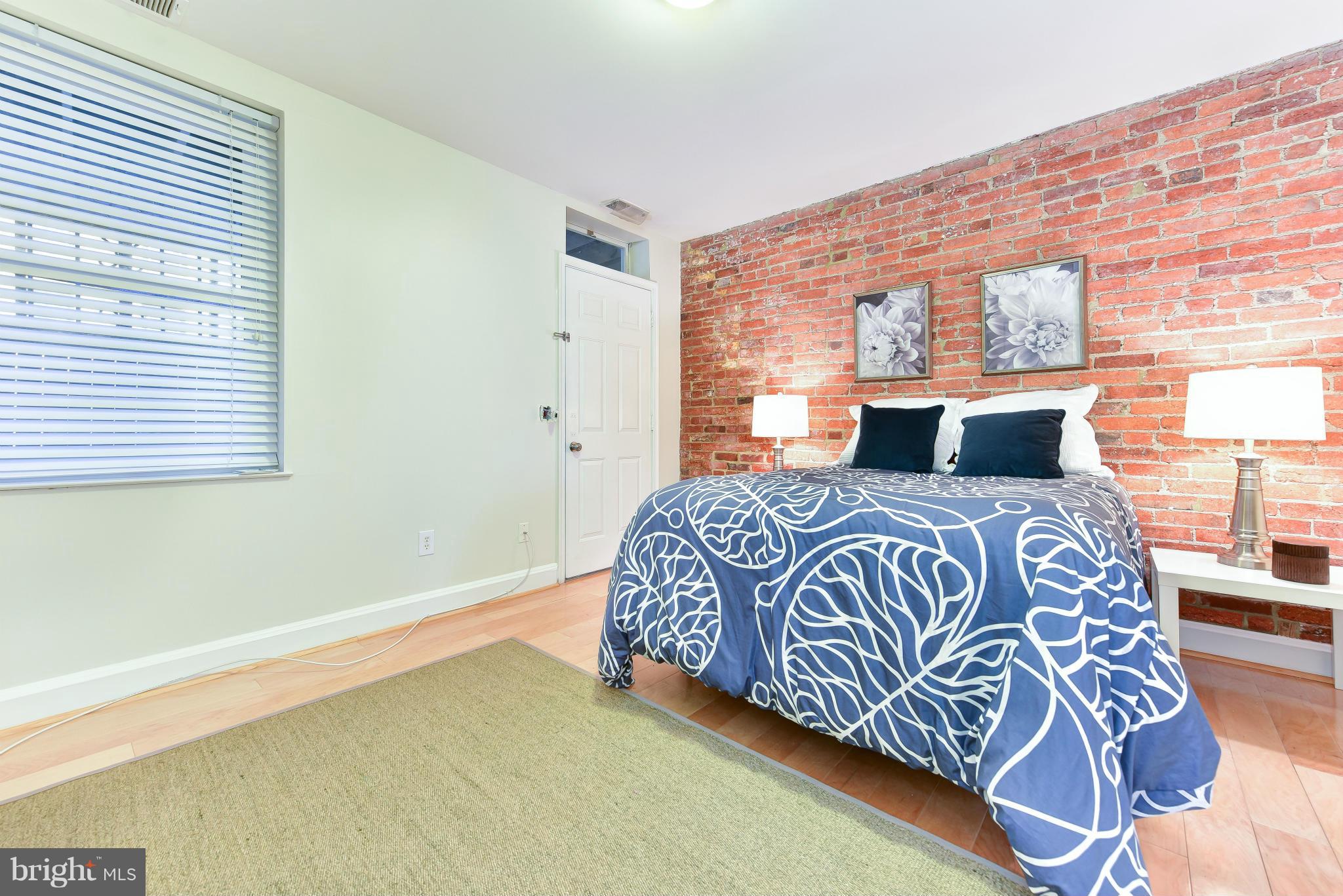 1749 Seaton Street Northwest Washington, DC 20009 - Photo 14 of 22 a bedroom with a large bed and a window
