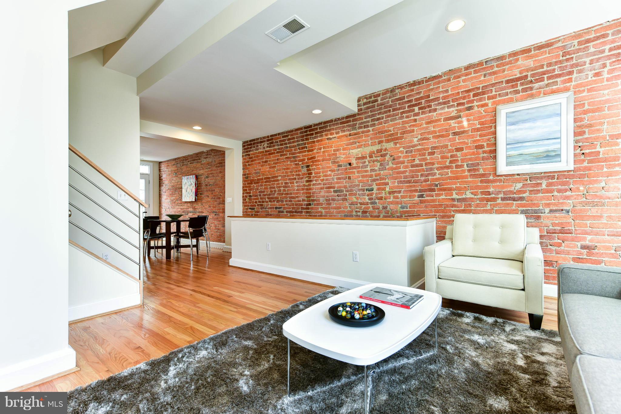 1749 Seaton Street Northwest Washington, DC 20009 - Photo 16 of 22 a living room with furniture and a wooden floor