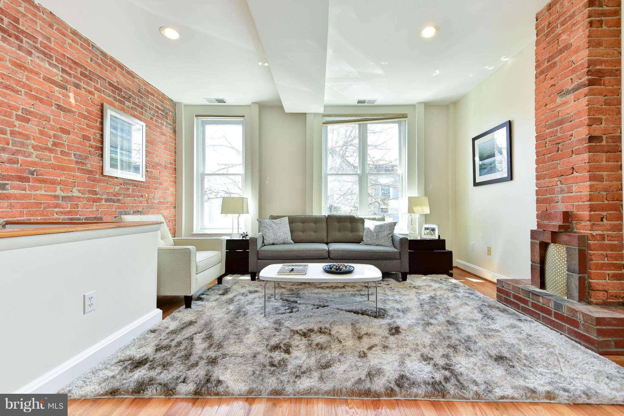 1749 Seaton Street Northwest Washington, DC 20009 - Photo 3 of 22 a living room with furniture and a fireplace