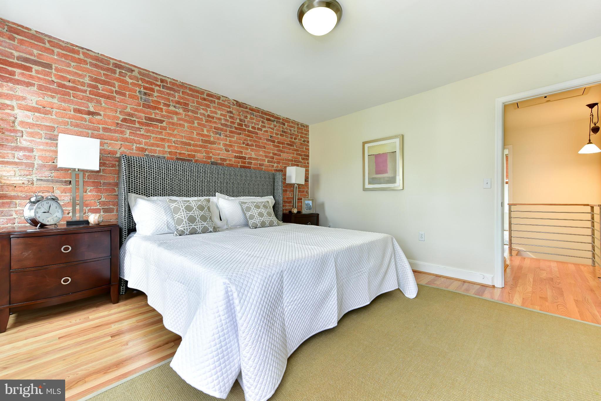 1749 Seaton Street Northwest Washington, DC 20009 - Photo 7 of 22 a bedroom with a bed and window