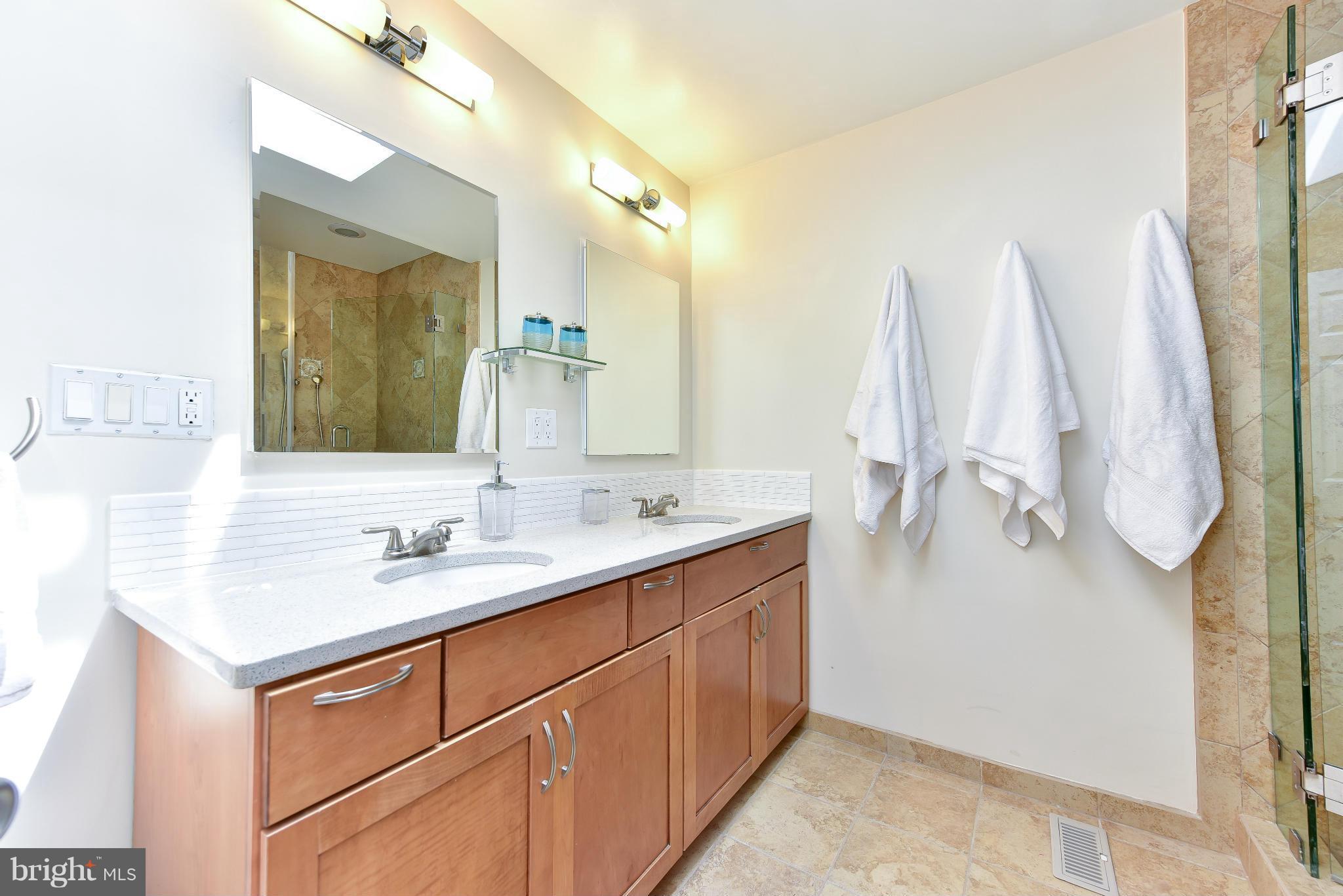 1749 Seaton Street Northwest Washington, DC 20009 - Photo 8 of 22 a bathroom with a sink vanity and mirror