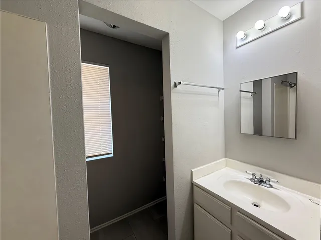 a bathroom with a sink vanity and mirror