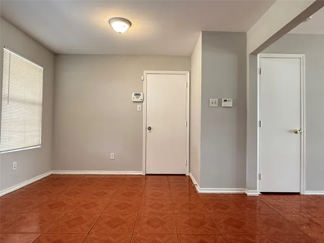 an empty room with closet and a window