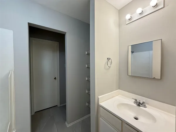 a bathroom with a sink vanity and mirror