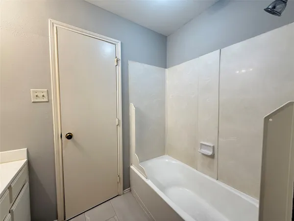 a bathroom with a tub and shower