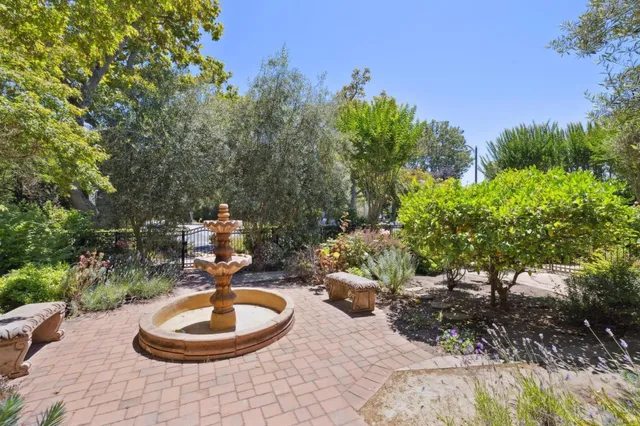 a view of an empty room with window and fire place