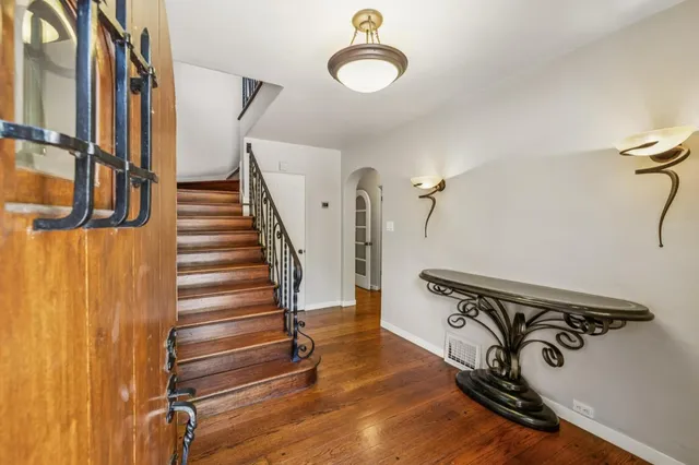 a view of a livingroom with furniture wooden floor chandelier