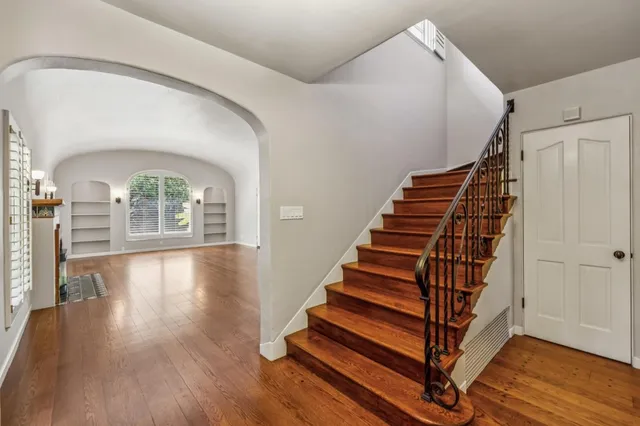a dining room with furniture and wooden floor