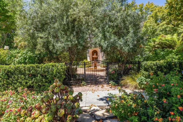 a backyard of a house with lots of green space and garden