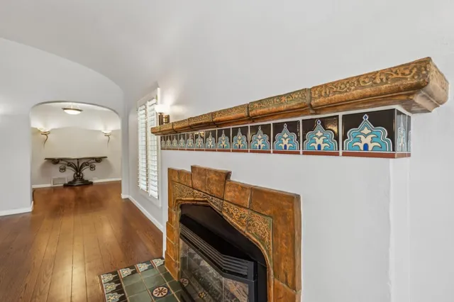 a view of an empty room with a fireplace and a window
