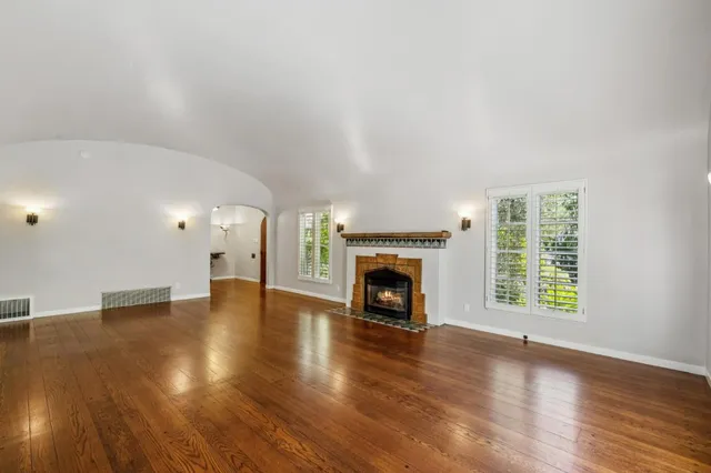 a bedroom with a window and a chandelier