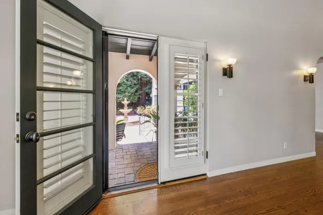 a bathroom with a granite countertop sink a large mirror and a bathtub next to a window