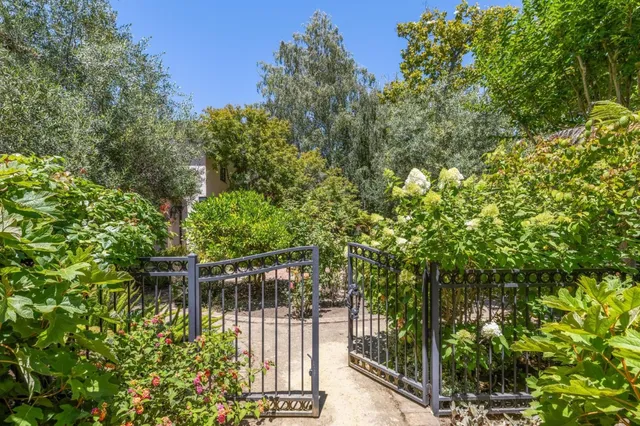 a view of empty room with wooden floor and window