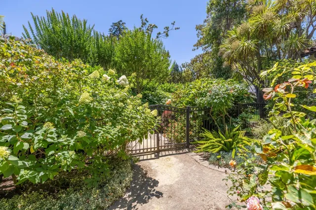 an empty room with floor to ceiling windows and a fireplace