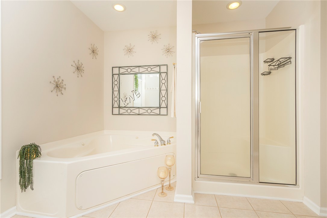 125 Inlet Pointe Drive Anderson, SC 29625 - Photo 25 of 39 Relaxation awaits with a jetted tub and an adjacent glass-enclosed shower for convenience.