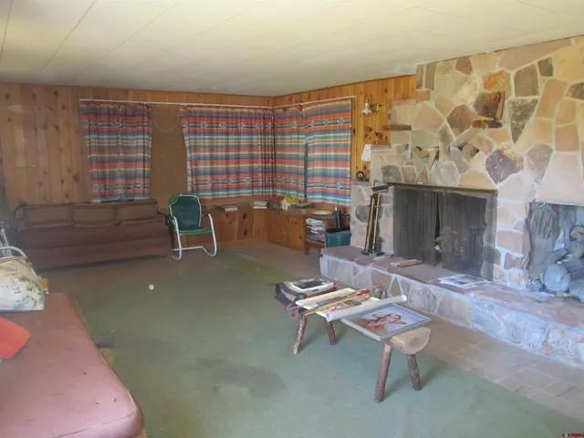 a living room with fireplace furniture and a window