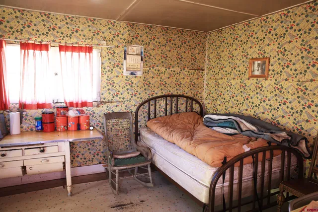 a room with chairs and a table with wooden floor