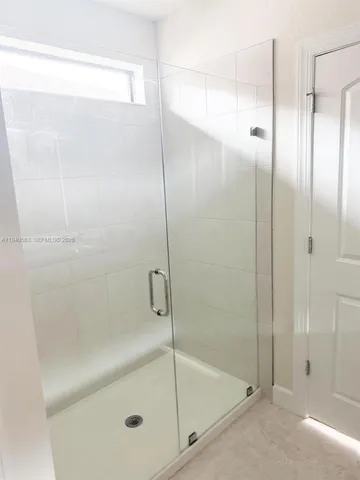 a bathroom with a glass shower door