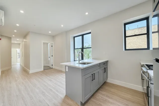 a kitchen with a stove and a wooden floors