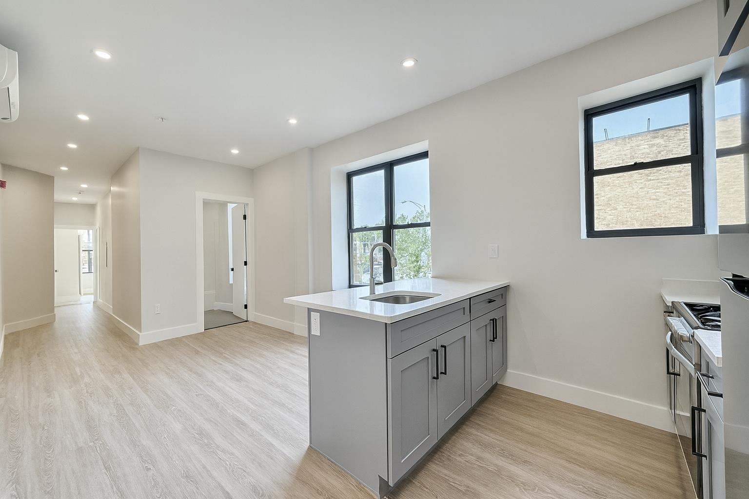 103 Bostwick Avenue, Unit 4B Jersey City, NJ 07305 - Photo 1 of 12 a kitchen with a stove and a wooden floors