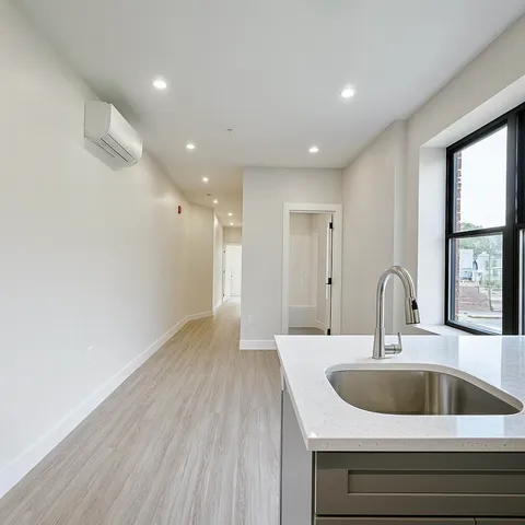 a kitchen with a sink and chandelier