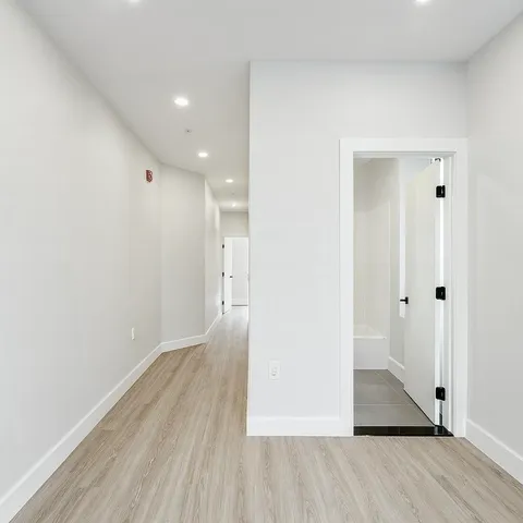 a view of hallway with wooden floor