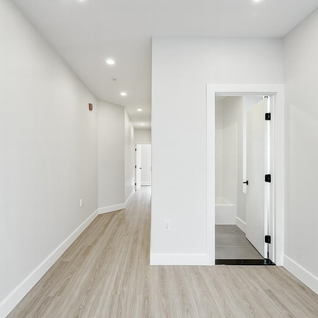 103 Bostwick Avenue, Unit 4B Jersey City, NJ 07305 - Photo 5 of 12 a view of hallway with wooden floor