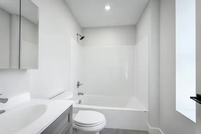 a bathroom with a toilet a sink and a bathtub