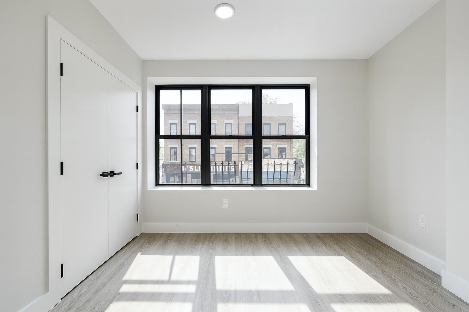 103 Bostwick Avenue, Unit 4B Jersey City, NJ 07305 - Photo 9 of 12 a view of an empty room with a window