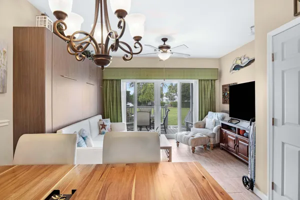 a dining room with furniture a chandelier and a rug