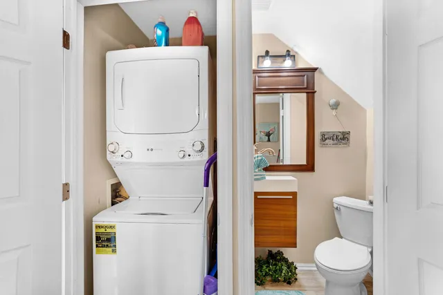 a bathroom with a toilet a sink and mirror