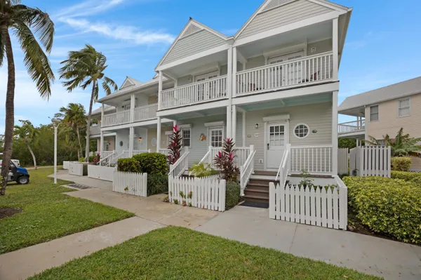 a front view of a house with a garden and plants