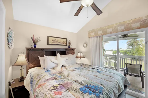 a bedroom with a bed and a flat tv screen on dresser