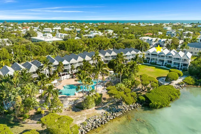 a view of a hallway with wooden floor and furniture