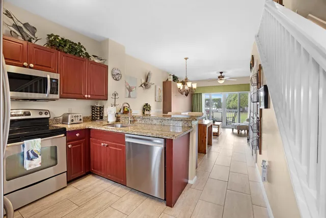 an aerial view of residential houses with outdoor space and trees
