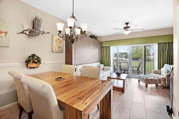 a kitchen with a stove a faucet a dining table and chairs