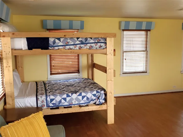 a bedroom with a bed and next to a window